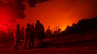 Firefighters are seen during a fire in Puren, Araucania region, Chile on February 4, 2023.