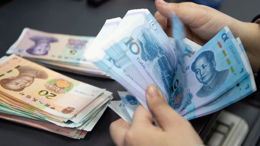 HAIAN, CHINA – JANUARY 24, 2024 – A staff member of the personal finance business area of a bank counts and arranges the RMB deposited by customers in the daily account in Haian city, Jiangsu province, China, Jan 24, 2024. (Photo credit should read CFOTO/Future Publishing via Getty Images)