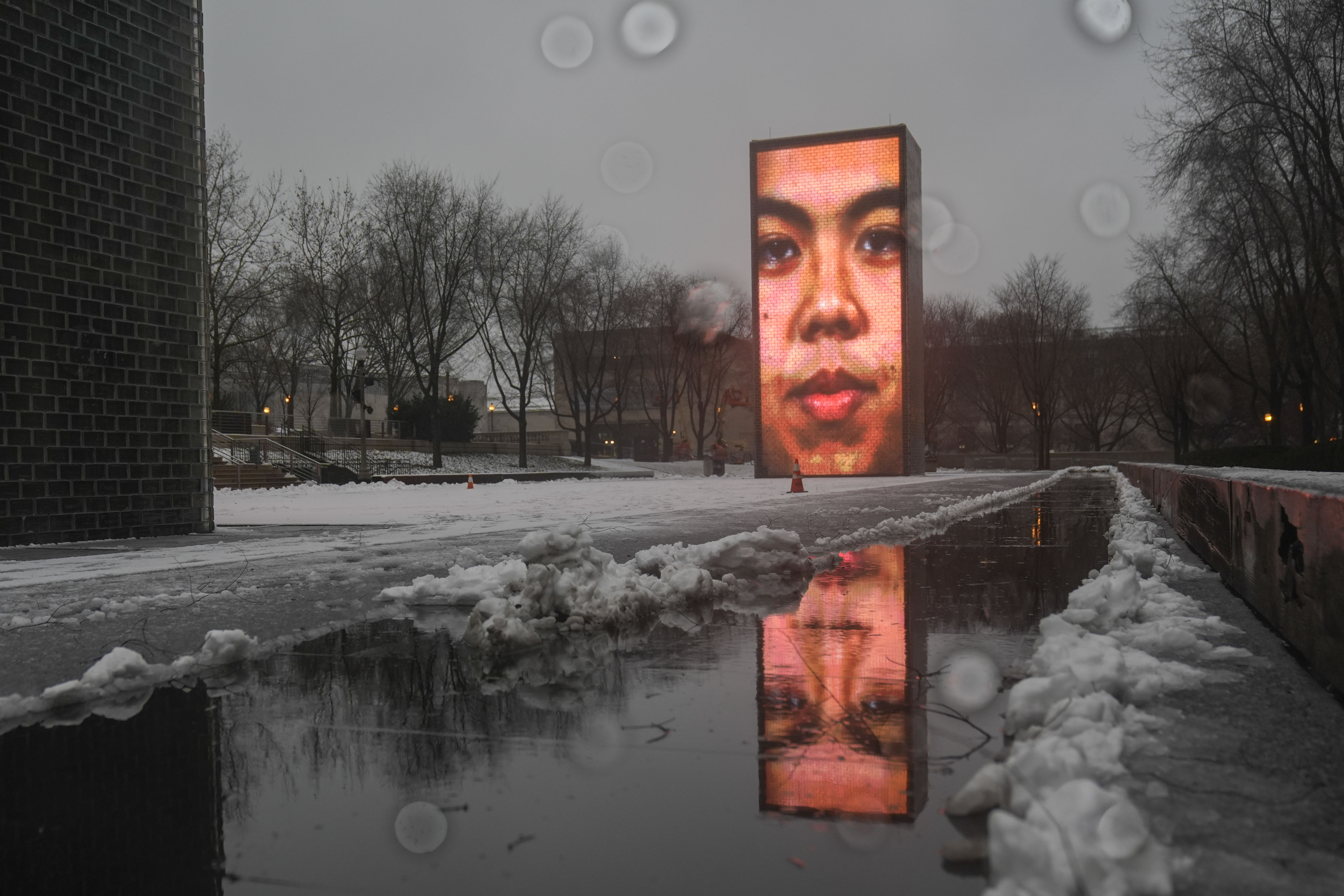 Snow falls on the Crown Fountain in Millennium Park during a winter storm, Friday, Jan. 12, 2024, in Chicago.