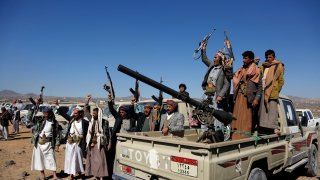 Houthi fighters and tribesmen stage a rally against the U.S. and the U.K. strikes on Houthi-run military sites near Sanaa, Yemen, on Sunday, Jan. 14, 2024.