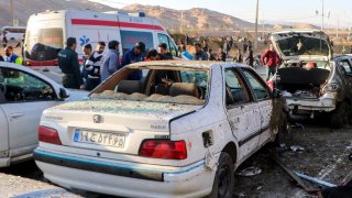 This photograph taken on Jan. 3, 2024 shows destroyed cars and emergency services near the site where two explosions in quick succession struck a crowd marking the anniversary of the 2020 killing of Guards general Qasem Soleimani, near the Saheb al-Zaman Mosque in the southern Iranian city of Kerman.