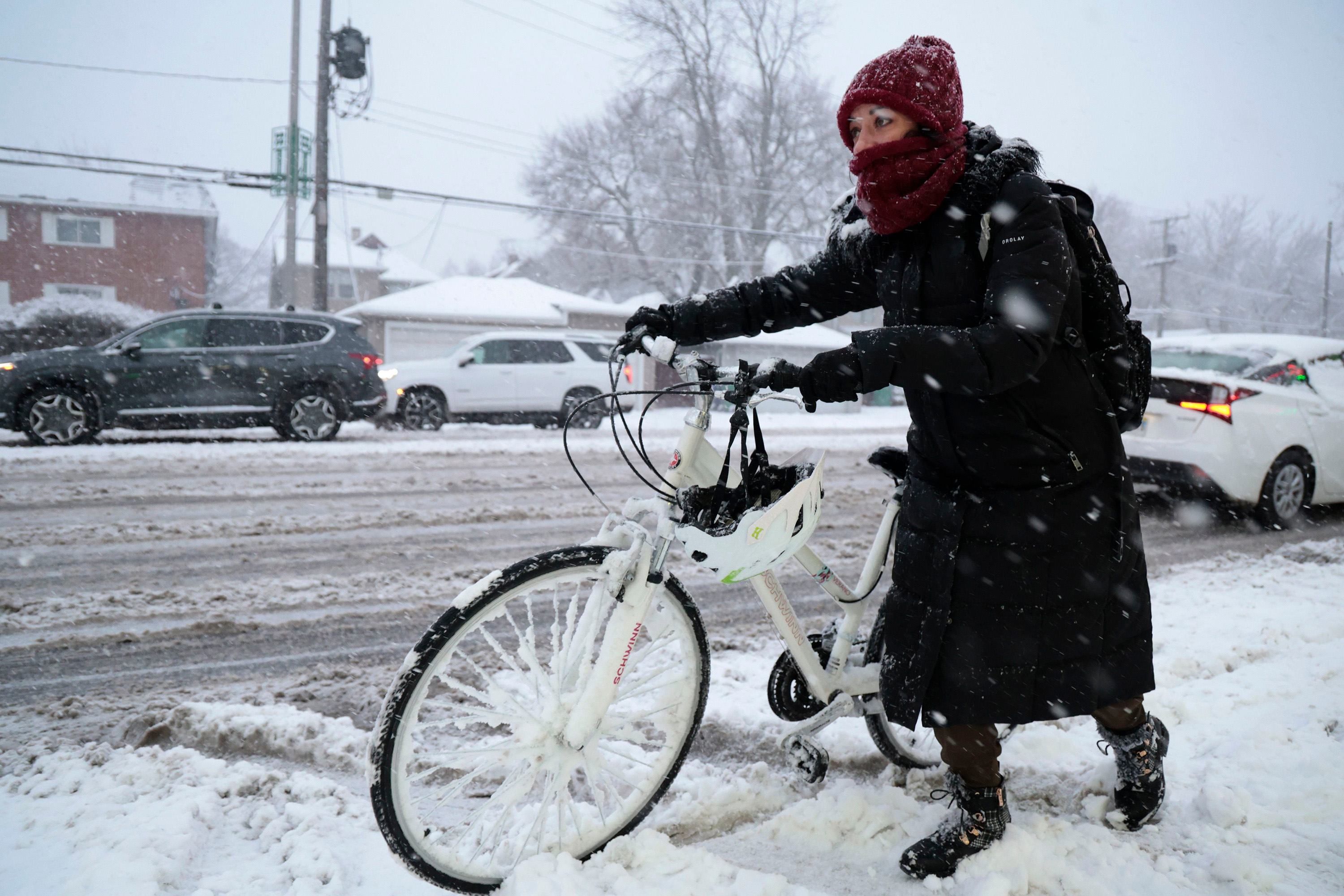 Rebecca Zimmerman moves along Harlem Avenue on her way to work in Oak Park from Forest Park as a winter storm hits the Chicago area with heavy snow and near-blizzard conditions, Jan. 12, 2024.