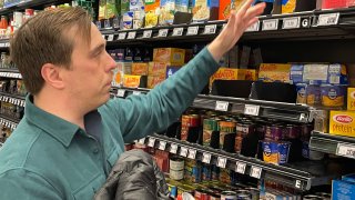 Stuart Dryden reaches for an item at a grocery store on Wednesday, Feb. 21, 2024,