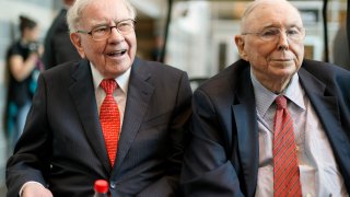 FILE- In this May 3, 2019 file photo, Berkshire Hathaway Chairman and CEO Warren Buffett, left, and Vice Chairman Charlie Munger, briefly chat with reporters before Berkshire Hathaway's annual shareholders meeting. Buffett credited his longtime partner — the late Charlie Munger — with being the architect of the Berkshire Hathaway conglomerate he’s received the credit for leading and warned shareholders in his annual letter not to listen to Wall Street pundits or financial advisors who urge them to trade often.