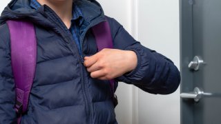 Student zipping up coat