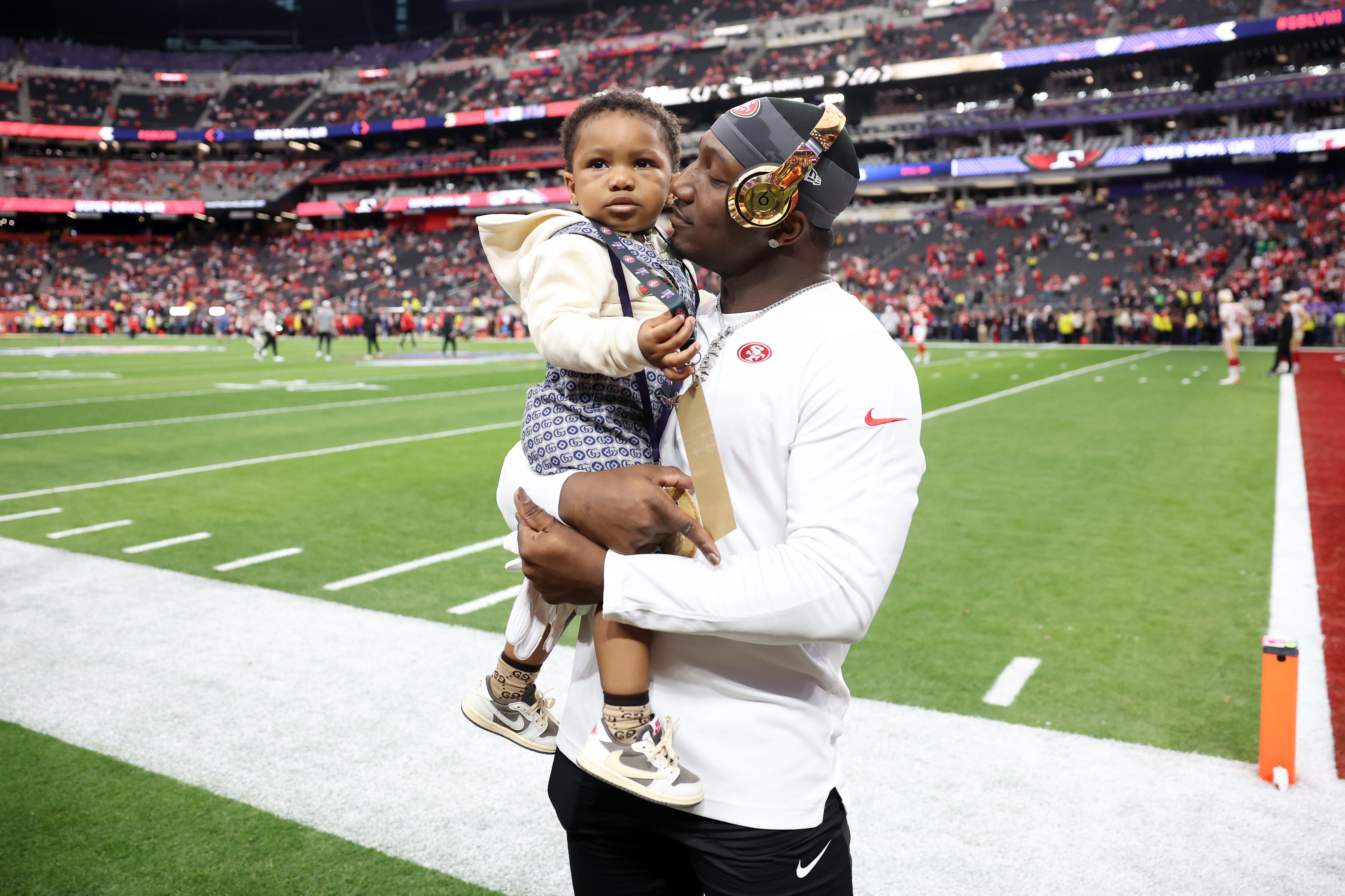 Deebo Samuel #19 of the San Francisco 49ers holds his child on the field before Super Bowl LVIII against the Kansas City Chiefs at Allegiant Stadium on February 11, 2024 in Las Vegas, Nevada.<br><em>(Photo by Ezra Shaw/Getty Images)</em>