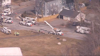 Utility workers on Bedford Street in Lexington, Massachusetts, responding to a truck crash that knocked down power poles Wednesday, Feb. 21, 2024.