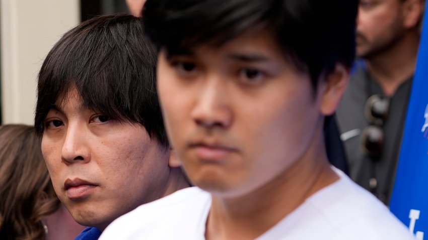 FILE -Ippei Mizuhara stands next to Japanese baseball star Shohei Ohtani and translates during an interview at Dodger Stadium on Feb. 3, 2024. Mizuhara has been fired by the Dodgers following allegations of illegal gambling and theft.