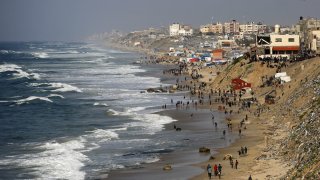 Palestinians wait for humanitarian aid airdrop at the beach in Deir al Balah, Gaza on Feb. 27, 2024.