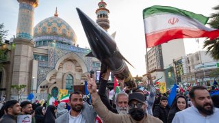 Unidentified men are carrying a model of Iran’s first-ever hypersonic missile, Fattah, past a mosque during a gathering to celebrate the IRGC UAV and missile attack against Israel, in Tehran, Iran, on April 15, 2024. 