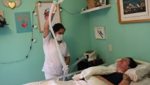 FILE -  A nurse readies a portable medical ventilator for Ana Estrada, a Peruvian psychologist, to receive oxygen in her bedroom, Lima, Peru, Dec. 18, 2019. Estrada, who suffered from an incurable disease and was authorized in 2022 by Peru's Supreme Court to receive euthanasia, has died, her lawyer said Monday, April 22, 2024. (AP Photo/Martin Mejia, File)