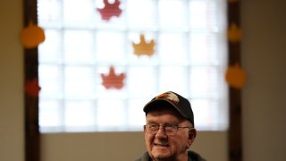 FILE – Earl Meyer, who fought for the U.S. Army in the Korean War, talks with fellow veterans at the American Legion, Nov. 7, 2023, in St. Peter, Minn.