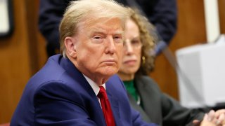 Former president Donald Trump waits with his lawyer Susan Necheles for the start of a hearing at Criminal Court on March 25, 2024 in New York City.