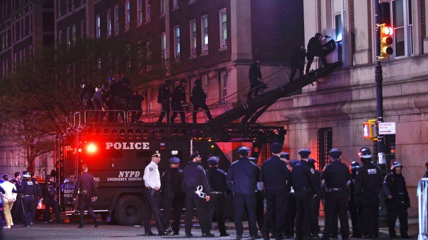 NYPD officers in riot gear break into a building at Columbia University, where pro-Palestinian students are barricaded inside a building and have set up an encampment, in New York City on April 30, 2024.