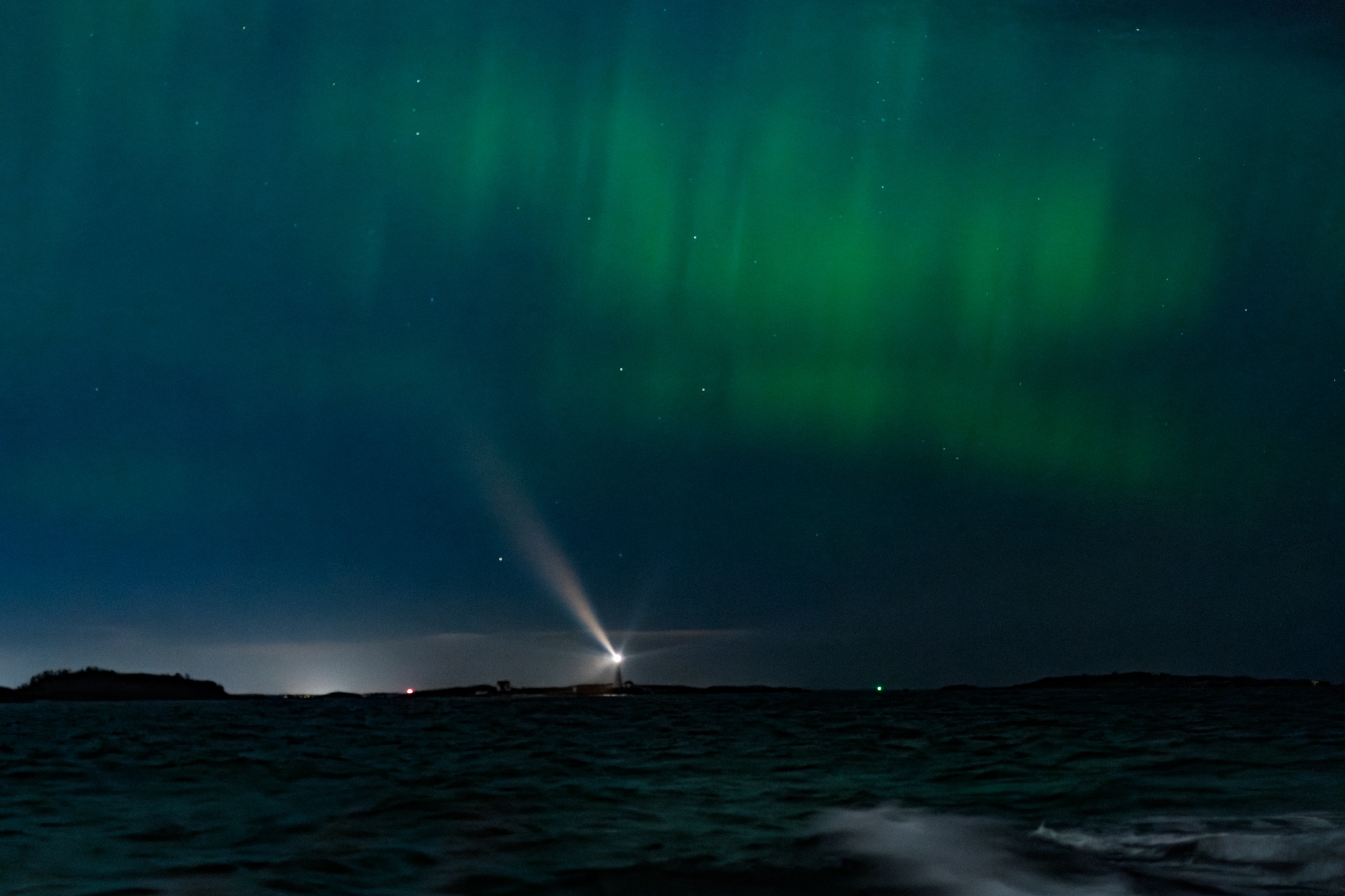 Photo of the Boston Light lighthouse under the Aurora Borealis taken from Hull