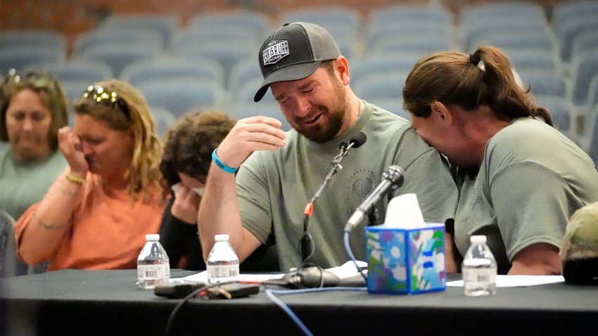 James Herling pauses his testimony while recalling the moment he realized the shooter was his brother-in-law, Robert Card, while testifying, Thursday, May 16, 2024, in Augusta, Maine, during a hearing of the independent commission investigating the law enforcement response to the mass shooting in Lewiston, Maine. Nicole Herling, sister of the shooter, cries on her husband’s shoulder.