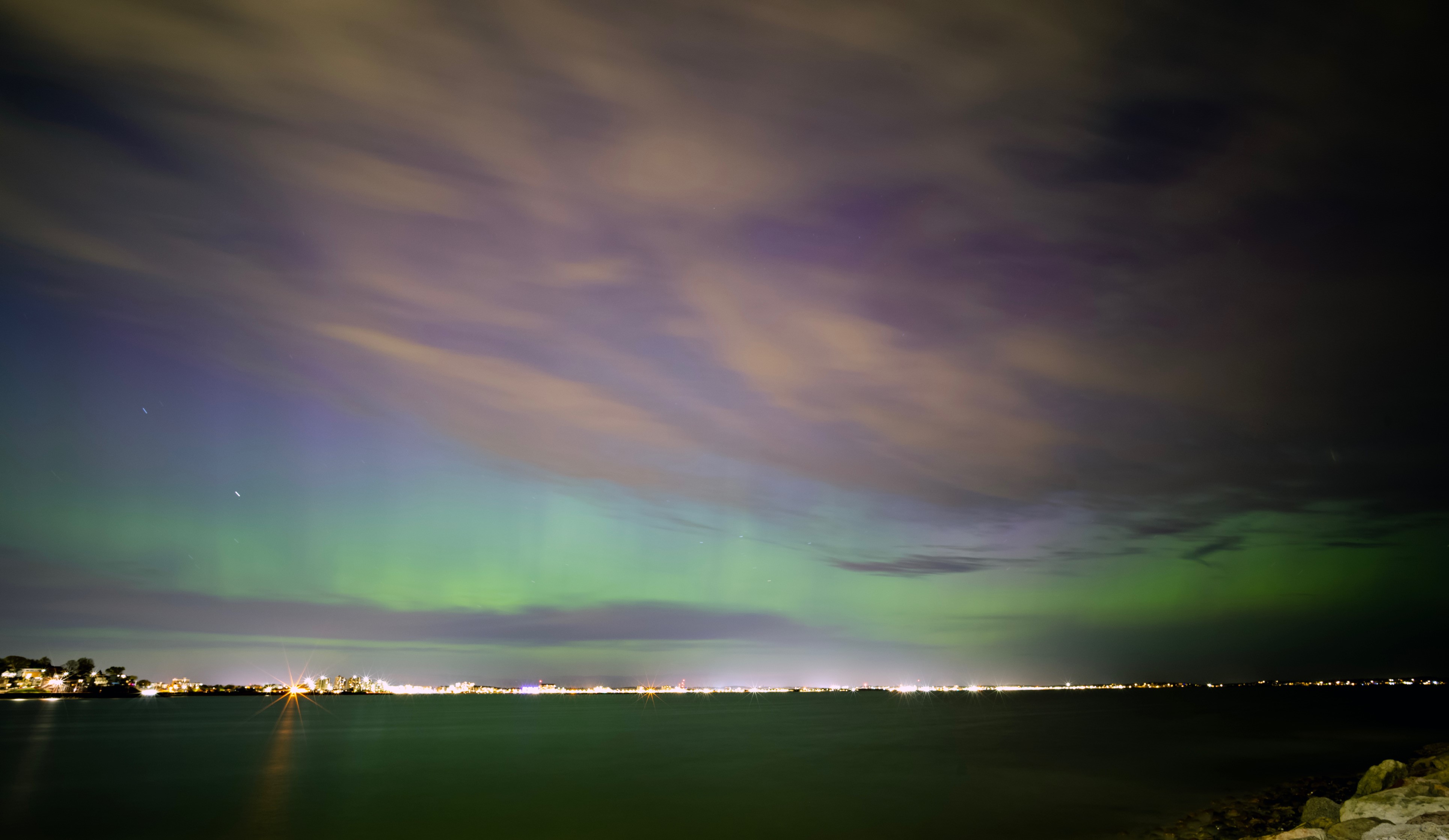 The northern lights as seen from Halford Beach in Winthorp, Massachusetts, with Revere Beach to the left