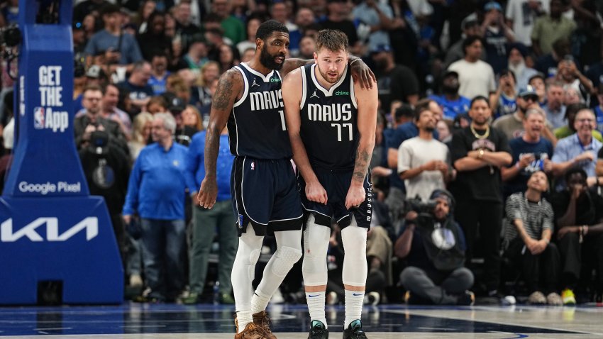 Kyrie Irving #11 embraces Luka Doncic #77 of the Dallas Mavericks during the game against the Minnesota Timberwolves during Game 3 of the Western Conference Finals of the 2024 NBA Playoffs on May 26, 2024 at the American Airlines Center in Dallas, Texas.