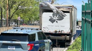 A box truck marked with the Trillium beer logo damaged after striking an overpass on Storrow Drive Friday.