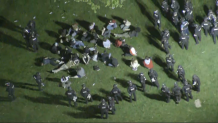 A group of people sitting on the campus of UMass Amherst, apparently in custody, surrounded by police on the night of Tuesday May 7, 2024. The university said about 130 people were arrested after refusing to break up a protest encampment.