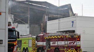 Emergency vehicles are parked next to the site of a fire at a lithium battery factory owned by South Korean battery maker Aricell in Hwaseong on June 24, 2024. 