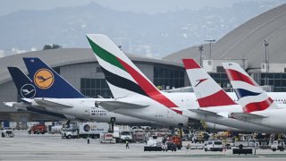 Ground crews load cargo and supplies onto airplanes from airlines including Lufthansa Group, Emirates, Austrian Airlines, and British Airways, as they stand parked at the Tom Bradley International Terminal (TBIT) at Los Angeles International Airport (LAX) in El Segundo, California, on September 11, 2023.