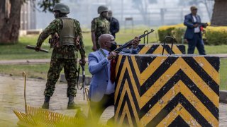 Kenya Police officers and security personnel take position to protect the Kenyan Parliament as protesters try to storm the building during a nationwide strike to protest against tax hikes and the Finance Bill 2024 in downtown Nairobi, on June 25, 2024. 