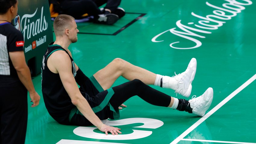 Boston Celtics center Kristaps Porzingis is slow to get up during the fourth quarter in Game 2 of the 2024 NBA Finals.