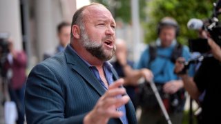 FILE – Alex Jones speaks to the media after arriving at the federal courthouse for a hearing in front of a bankruptcy judge, Friday, June 14, 2024, in Houston.