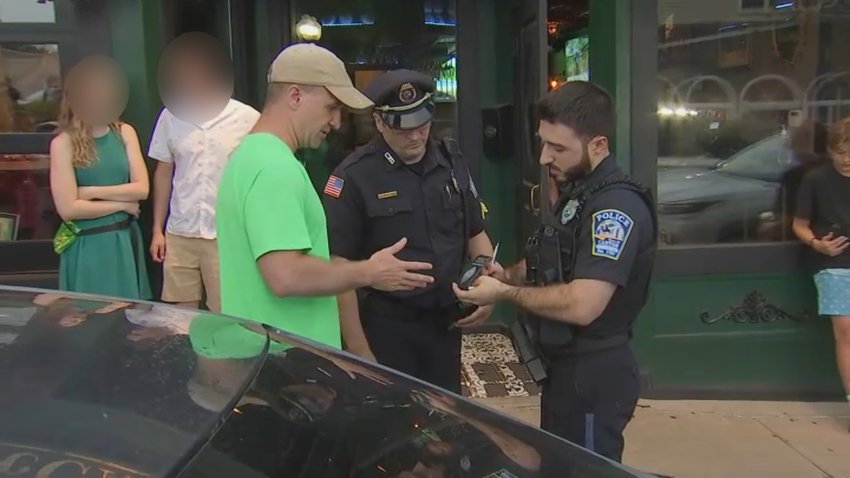 Aidan Kearney speaks with Canton police officers after a confrontation outside a local bar on June 23, 2024.