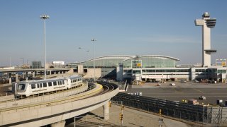 “International terminal, train, and control tower at New York’s Kennedy Airport”