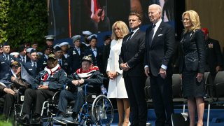 President Joe Biden (C), first lady Jill Biden (R), France’s President Emmanuel Macron (2nd L) and French President’s wife Brigitte Macron (L) stand to attention during the US ceremony marking the 80th anniversary of the World War II “D-Day” Allied landings in Normandy, at the Normandy American Cemetery and Memorial in Colleville-sur-Mer on June 6, 2024.