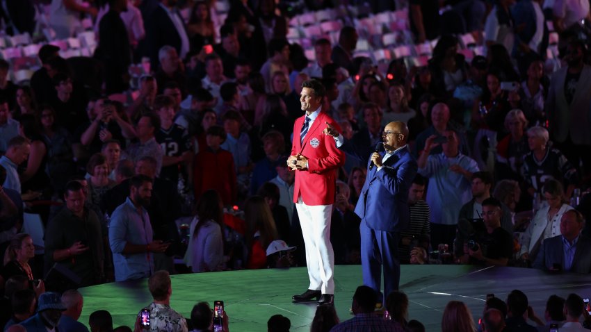 Tom Brady and Mike Tirico speak to fans during the 2024 Hall of Fame Induction Ceremony for Tom Brady at Gillette Stadium on June 12, 2024 in Foxborough, Massachusetts.