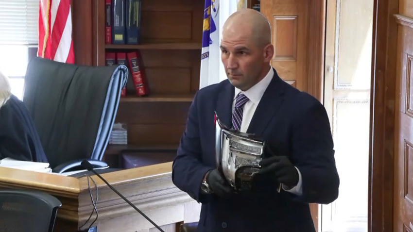 Massachusetts State Police investigator Michael Proctor holds a taillight in Norfolk Superior Court during the murder trial of Karen Read on Monday, June 10, 2024.