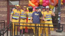 Six Savannah Bananas players posing outside of Dunkin' in Kenmore Square.