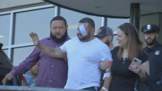 Springfield Police Officer Nestor Santos waves as he's discharged from Massachusetts General Hospital in Boston on Thursday, June 13, 2024.