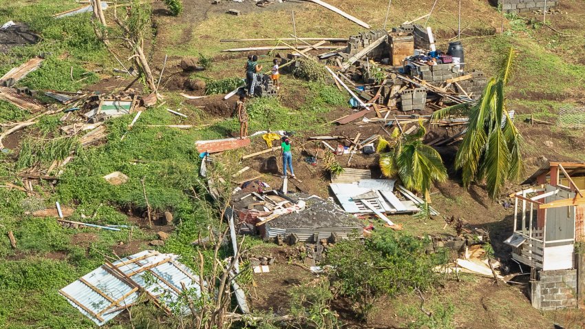 Family members survey their home destroyed in the passing of Hurricane Beryl, in Ottley Hall, St. Vincent and the Grenadines, Tuesday, July 2, 2024.