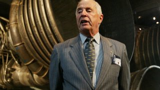 FILE – Apollo 8 Lunar Module Pilot Gen. William Anders, speaks to reporters in front of the Saturn 5 Aft End, the F-1 rocket engines of the first stage of the Apollo 11/Saturn 5 launch vehicle ,July 20, 2004, in Washington.