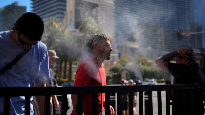 People cool off in misters along the Las Vegas Strip.