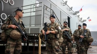 Soldiers leave for a patrol at the military camp set up in the Vincennes woods, Monday, July 15, 2024 just outside Paris.