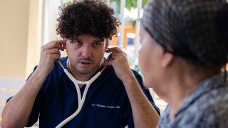 Dr. Pedro Juan Vázquez, better known by his stage name PJ Sin Suela, attends to a patient in Loiza, Puerto Rico, Saturday, May 25, 2024. The 34-year-old doctor travels from the San Juan capital to the island’s southern and central regions to treat communities struggling in the aftermath of hurricanes. After hanging up his doctor’s scrubs, Vázquez spends his time producing new music that relays the island’s issues.