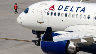 FILE - A Delta Air Lines jet leaves the gate, Friday, July 19, 2024, at Logan International Airport in Boston. Some airline issues are continuing on Monday after a faulty software update caused technological havoc worldwide and resulted in several carriers grounding flights, but the number of flights impacted is declining.