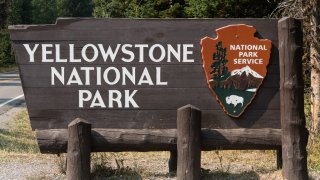 The wooden entrance sign to Yellowstone National Park,  USA.