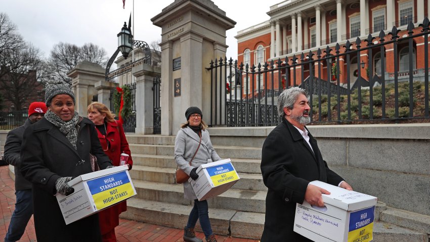 Boston, MA – December 6: The Massachusetts Teachers Association held a press conference on the State House steps, touting the 135,000 signatures gathered in support of a ballot question that aims to remove the high school graduation requirement tied to high-stakes MCAS testing and afterwards brought them to the capitol on the last day of acceptance. (Photo by David L. Ryan/The Boston Globe via Getty Images)