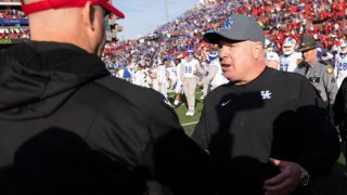 Under the three different antitrust suits filed by ex-athletes vs. the NCAA, then Kentucky football coach Mark Stoops, right, and Louisville head man Jeff Brohm, left, will probably find themselves coaching teams with players being paid directly by their schools.