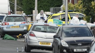 Forensic officers attend the scene of a multiple stabbing attack on July 29, 2024 in Southport, England. The North West Ambulance Service says they were treating at least eight people for stab injuries after a reported attack near Hart Street.