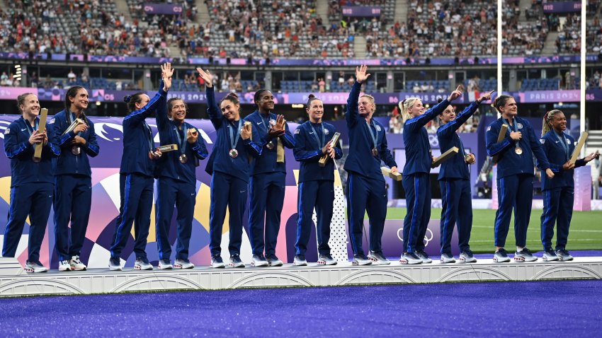 US’ players celebrate with their bronze medals on the podium during the victory ceremony following the women’s gold medal rugby sevens match between New Zealand and Canada during the Paris 2024 Olympic Games at the Stade de France in Saint-Denis on July 30, 2024.