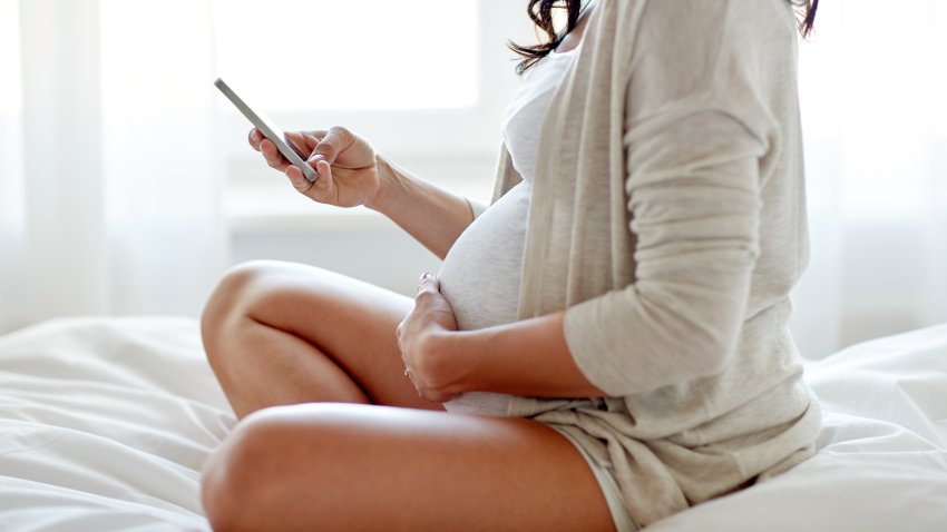 Pregnant woman on her phone