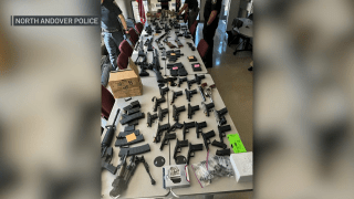 Dozens of guns and ammunition laid out after a major bust in North Andover, Massachusetts, on Tuesday, July 2, 2024.