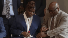 Harris Wolobah's parents at a news conference in Boston Thursday, July 11, 2024, announcing a family lawsuit over the Worcester teenager's death after eating the chip from the One Chip Challenge in 2023.